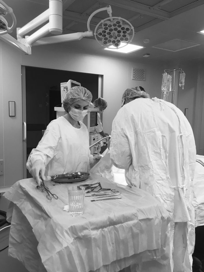 Home Black and white image of surgeons working in an operating room, focused on healthcare and medical procedures.